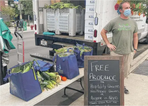  ?? FACEBOOK ?? After Nichols Farm and Orchard was told July 28 it no longer could sell at the Wicker Park Farmers Market, Nick Nichols showed up anyway on Sunday, parked next to the market and gave away a truckload of produce. The chamber of commerce said Nichols’ stand was removed due to violations of COVID-19 protocol.