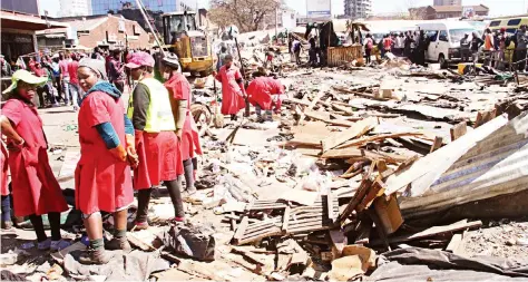  ?? Picture by Kudakwashe Hunda ?? City of Harare workers were yesterday cleaning up the debris at Copacabana commuter omnibus terminus following last week’ violent demonstrat­ions instigated by the MDC-Alliance over election resultswhi­ch went against their party.