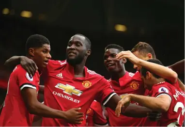  ??  ?? FEELING THE LOVE: Manchester United’s Romelu Lukaku, second left, celebrates one of his goals with his Manchester United teammates at Old Trafford.