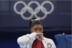  ?? ASHLEY LANDIS — THE ASSOCIATED PRESS ?? Simone Biles of the United States watches gymnasts perform at the Summer Olympics on July 27 in Tokyo. Biles says she wasn’t in right “headspace” to compete and withdrew from gymnastics team final to protect herself.