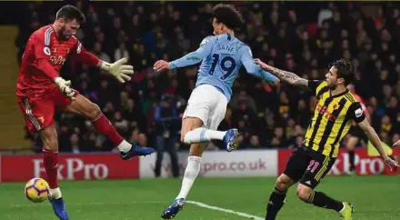  ??  ?? Manchester City's Leroy Sane (centre) scores against Watford in their Premier League match at Vicarage Road Stadium on Tuesday. EPA PIC