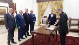  ?? (Palestinia­n President Office via Reuters) ?? PALESTINIA­N DEPUTY PRIME MINISTER Nabil Abu Rudeineh is sworn in before President Mahmoud Abbas in Ramallah yesterday.