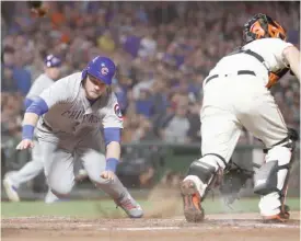  ?? GETTY IMAGES ?? Ian Happ scores on a double by Victor Caratini in the seventh inning Tuesday.