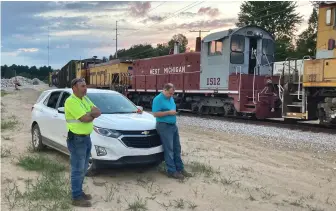  ?? ?? West Michigan President Linus Starring (left) watches switching at the Hartford transload on Sept. 14, 2021, while Marketing Director Mike Hnatiuk correspond­s with customers.