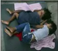  ?? MARCO UGARTE — AP ?? Migrant children sleep on a mattress on the floor of the AMAR migrant shelter in Nuevo Laredo, Mexico, Wednesday. Asylum-seekers grappled to understand what a new U.S. policy that all but eliminates refugee claims by Central Americans and many others meant for their bids to find a better life in America amid a chaos of rumors, confusion and fear.