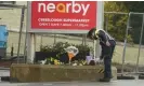  ?? Photograph: Brian Lawless/PA ?? A Garda officer lays flowers near the scene of the explosion on Sunday.