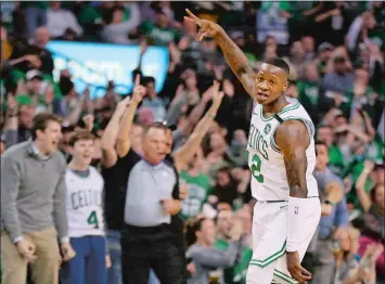  ?? ELISE AMENDOLA/AP PHOTO ?? Boston Celtics guard Terry Rozier (12) celebrates his 3-point shot against the Philadelph­ia 76ers in the first quarter of Game 1 Monday night in Boston. The Celtics won 117-101 to take the early series lead in the Eastern Conference semifinals.