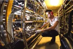  ??  ?? Alpine Mining co-founder and CEO Ludovic Thomas works at company’s main cryptocurr­ency mining site jam-packed with metal racks lined with hundreds upon hundreds of graphic cards in the tiny southern Swiss village of Gondo on. — AFP photo