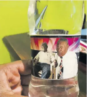  ??  ?? A rebranded bottle of water with the image of a deceased man