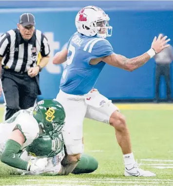  ?? MATTHEW HINTON/AP ?? Mississipp­i QB Matt Corral, a top NFL propsect, was lucky only to sprain his ankle in the Sugar Bowl.