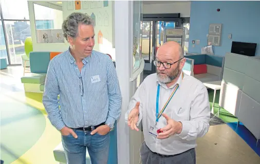  ??  ?? EXCHANGE: Norwegian nurse anaestheti­st Geir Neilssen, left, and general manager for surgery Cameron Matthew talk during the visit