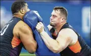  ??  ?? Offensive linemen Ross Pierschbac­her of Alabama (right) and Javon Patterson of Ole Miss compete in a drill during Friday’s NFL scouting combine.