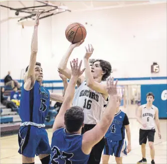  ?? BOB TYMCZYSZYN THE ST. CATHARINES STANDARD ?? Lakeshore Catholic’s Nick Cryer (16) goes up for a layup in consolatio­n quarter-final action versus Eden at the Standard High School Boys Basketball Tournament Tuesday night in St. Catharines.