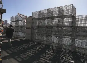  ?? Liz Hafalia / The Chronicle ?? Crab cages sit at Pier 45 at Fisherman’s Wharf in November, around the usual start of the season, which was delayed by whales and now by a pricing dispute.