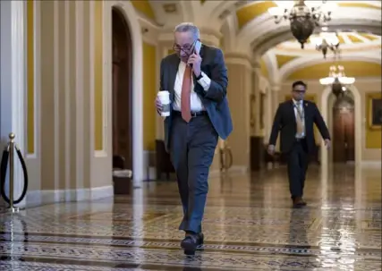  ?? J. Scott Applewhite/Associated Press ?? Senate Majority Leader Chuck Schumer, D-N.Y., arrives at the Capitol last week while Republican­s hold a closeddoor meeting after blocking a bipartisan border package that had been tied to wartime aid for Ukraine.
