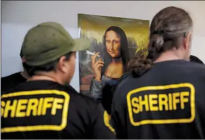  ?? AP/JAE C. HONG ?? Los Angeles County sheriff’s deputies raid an illegal marijuana shop in Compton, Calif., in March.