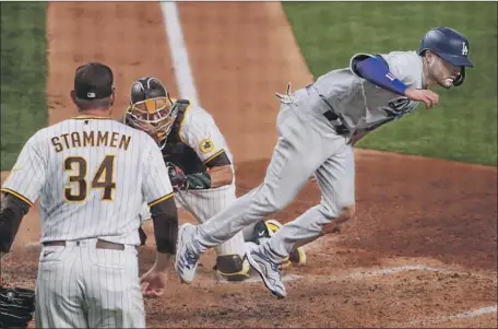  ?? Robert Gauthier Los Angeles Times ?? AJ Pollock scores in the third inning on a Joc Pederson single. Pederson got his f irst two hits and RBI of the postseason.