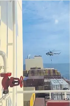  ?? AFP ?? Iran’s Revolution­ary Guards rappel down from a helicopter onto the container ship MSC Aries near the Strait of Hormuz on Saturday.