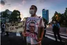  ?? Yuichi Yamazaki/Getty Images ?? A protester holds a placard with a picture of Thomas Bach during a demonstrat­ion against the Games, earlier this week. Photograph: