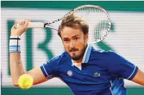 ?? JEAN-FRANCOIS BADIAS/ASSOCIATED PRESS ?? Russia’s Daniil Medvedev returns the ball to Marin Cilic during the French Open in May. Medvedev, ranked No. 1 and the reigning U.S. Open champion, is banned from playing at Wimbledon.