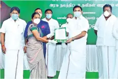  ??  ?? Chief Minister handing over job order to wife of a martyr during a programme in Ramanathap­uram on Tuesday.