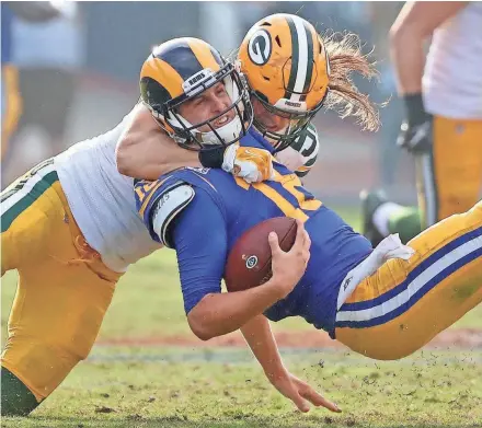  ?? JIM MATTHEWS/USA TODAY NETWORK-WIS ?? Packers linebacker Clay Matthews (52) tackles quarterbac­k Jared Goff (16) for a third down stop against the Rams on Sunday at the Memorial Coliseum in Los Angeles.