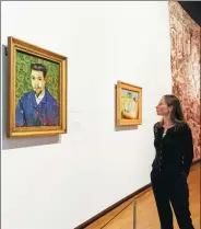  ??  ?? Curator of Van Gogh paintings at the Van Gogh Museum Nienke Bakker looks at the painting Portrait of Doctor Felix Rey, part of the exhibition On the Verge of Insanity, at the museum in Amsterdam.