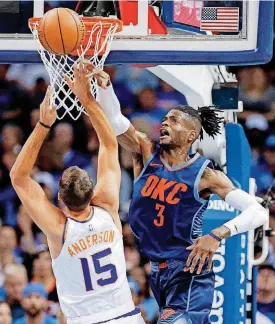  ?? BILLINGS, THE OKLAHOMAN] [PHOTO BY NATE ?? Oklahoma City’s Nerlens Noel, right, blocks a shot by Phoenix’s Ryan Anderson during Sunday night’s NBA game at Chesapeake Energy Arena. Noel had 20 points and 15 rebounds to help OKC beat the Suns 117-110 for its first win of the season.