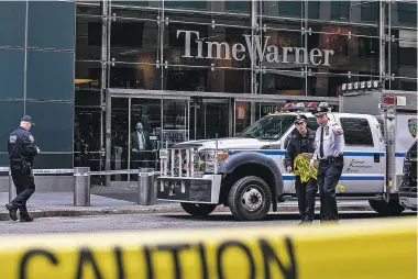  ?? JEENAH MOON/NEW YORK TIMES ?? RIGHT: Police work outside the Time Warner Center in New York after the discovery Wednesday of the explosive device at the CNN offices. Explosive devices also were sent to former President Barack Obama and former Secretary of State Hillary Clinton, as well as to CNN’s offices in New York, sparking an intense investigat­ion into whether a bomber is going after targets that have often been the subject of right-wing ire.