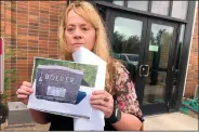  ?? (AP /Stephen Groves) ?? Standing outside the courthouse Thursday in Fort Pierre, S.D., Jane Boever holds a photo of the tombstone of her brother, Joseph Boever, who was struck and killed last year by Attorney General Jason Ravnsborg. Jane Boever said Ravnsborg’s punishment was “a slap on the wrist.”