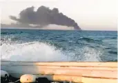  ?? ASRIRAN.COM ?? An image from video taken Wednesday shows smoke rising from the largest warship in Iran’s navy after it caught fire. The ship later sank in the Gulf of Oman.