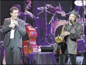  ?? BILL HUGHES/LAS VEGAS REVIEW-JOURNAL ?? Clint Holmes, left, performs with Kirk Whalum during a Ray Charles tribute that closed early. He is returning to the Strip with a new show.