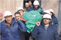  ?? FERAS DOMY/ASSOCIATED PRESS ?? Comrades carry Ilias Mahmoud al-Taweel, a member of the Syrian Civil Defense, or White Helmets, during his funeral in Douma, a suburb of Damascus. Taweel died during a rescue.