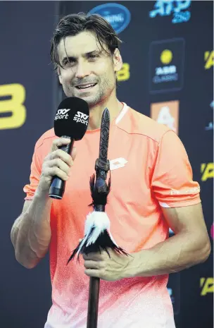  ?? PHOTO: GETTY IMAGES ?? Thank you and farewell . . . Fourtime champion David Ferrer, holding a ceremonial Maori taiaha, bids a final farewell to fans after retiring injured at the ASB Classic in Auckland yesterday.