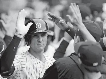  ?? NOAH K. MURRAY/AP PHOTO ?? Yankees first baseman Greg Bird celebrates in the dugout after hitting a grand slam in the first inning of Sunday’s 10-2 win over the Toronto Blue Jays at Yankee Stadium.