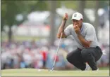  ?? The Associated Press ?? Tiger Woods studies a chip shot on the fourth green during the second round of the PGA Championsh­ip at Bellerive Country Club on Friday in St. Louis.