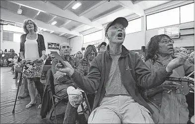  ?? [HAYNE PALMOUR IV/THE SAN DIEGO UNION-TRIBUNE] ?? Hieu Dovan yells “Vote no” on the Republican health care plan, after cancer patient Barbara Main, left, asked whether people with pre-existing conditions will be covered. They were at a town hall meeting hosted by U.S. Rep. Darrell Issa, R-Calif., on...