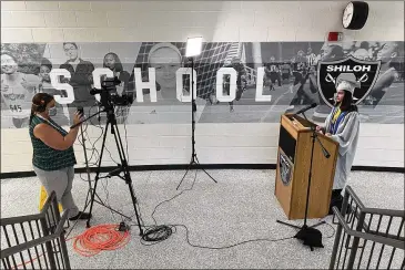  ?? GWINNETT COUNTY PUBLIC SCHOOLS ?? Heather O’Shaughness­y, with GCPS Broadcast and Distant Learning, records Shiloh High School valedictor­ian Miriam Martinez Rivera giving her speech for the virtual graduation to air this afternoon.
