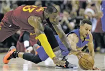  ?? AP FILE PHOTO ?? The Cavaliers’ LeBron James, left, and the Warriors’ Stephen Curry battle for a loose ball during a Dec. 25 game in Cleveland. The Warriors and the Cavaliers are being penciled in to meet in the NBA Finals once again. They’re going to drive most of the...