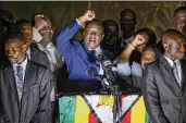  ?? BEN CURTIS / AP ?? Zimbabwe’s incoming leader Emmerson Mnangagwa (center) greets supporters at ZANU-PF headquarte­rs Wednesday in Harare, Zimbabwe.