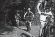  ?? NWA Democrat-Gazette/SPENCER TIREY ?? Members of several NICA mountain biking teams practice July 13 at Slaughter Pen mountain biking trail in Bentonvill­e. NICA begins its second year in September with a five-race schedule.