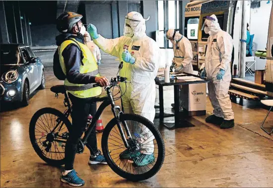  ?? LUCA ZENNARO / EFE ?? Sanitarios de la Marina italiana haciendo ayer tests del coronaviru­s en la feria de Génova