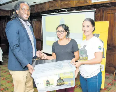  ??  ?? Nalford Hyde, project manager at TEF, presents a clean-up kit to Samita Mandjee of Knox Community College with the help of Suzanne Stanley (right), CEO of JET. Knox Community College will be staging a clean-up of Spaldings in Clarendon.