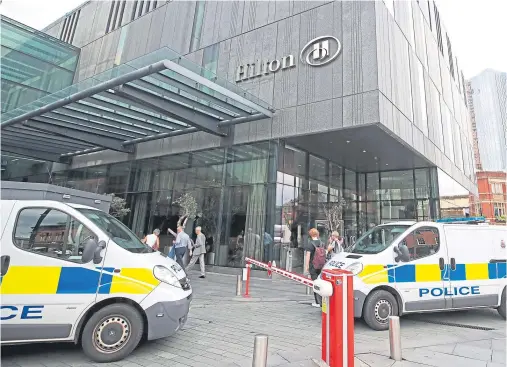  ??  ?? CRIME SCENE: A woman had her throat slashed in an attack at the Hilton Hotel in Deansgate, Manchester