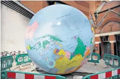  ??  ?? The upside down globe, with China in yellow and Taiwan in pink. Below, Mark Wallinger