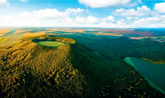  ??  ?? Aerial view of a volcano in Wudalianch­i Biosphere Reserve