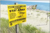  ?? Christian Abraham / Hearst Connecticu­t Media ?? Signs like this one — at Long Beach in Stratford on June 28 — help remind visitors to keep away from nests for the piping plover population.