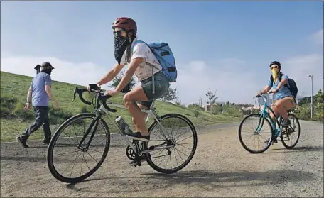  ?? Photograph­s by Christina House Los Angeles Times ?? AIMEE GILCHRIST, left, Explorers Club president, and UCLA Chicano Studies professor Marissa López on part of their ride.