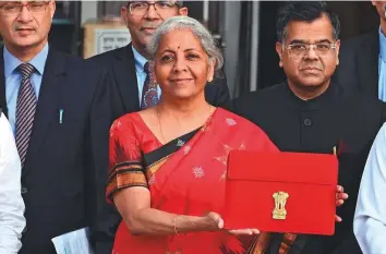  ?? Bloomberg ?? Nirmala Sitharaman, India’s finance minister, center, and other members of the finance ministry leave the ministry to present the budget at the parliament in New Delhi, yesterday.