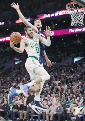  ?? AP FOTO ?? HIGHLIGHT PLAY. Jayson Tatum of the Boston Celtics drives hard to the basket over Dallas Maverick center Maxi Cleber in the first quarter of an NBA game.